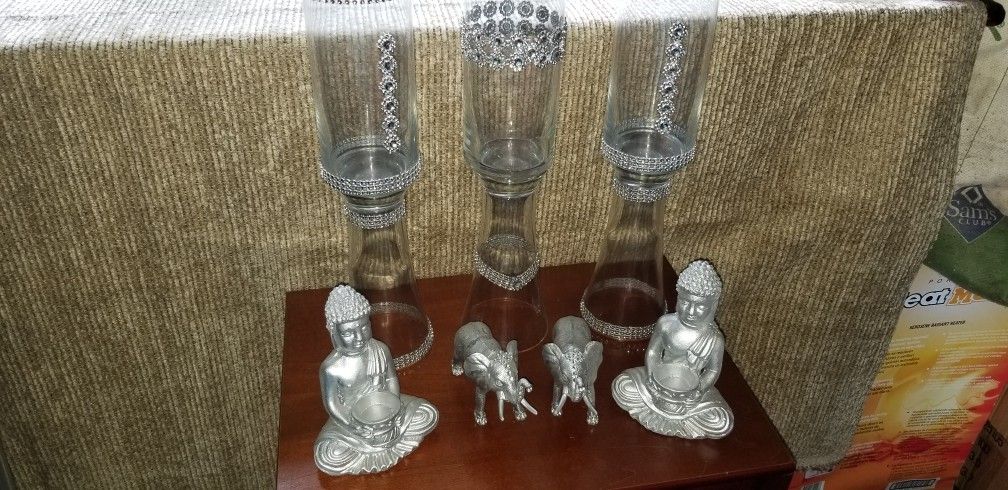 Glass vases with buddha candle holders