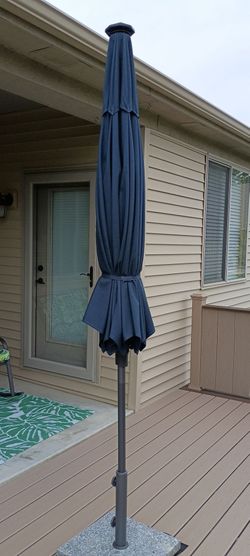 Navy Blue Outdoor Patio Umbrella solar LED lights with granted Stand  size umbrella 8 feet wide new condition asking $80 dollars