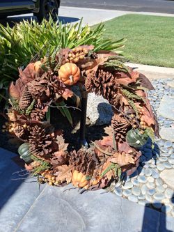 24" Autumn wreath with faux pumpkins, pinecones, fall leaves, and berry clusters. Great for front door or wall display...asking $25.00