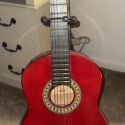 Red basic nylon-string (classical) guitar. 