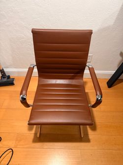 Big executive office chair, brown quilted faux leather with a padded headrest and thick armrests. Reclines and swivels, height adjustable, chrome base