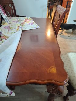 Large dining table with four regular chairs and two captains chairs