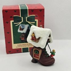 New  Hallmark Ornament Children in Shoe boot Christmas once upon a time nursery 

Dated 1985
Ornament in mint condition, kept in the box
Box has some 