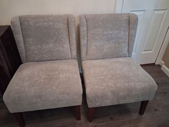 Pair of armless accent chairs.