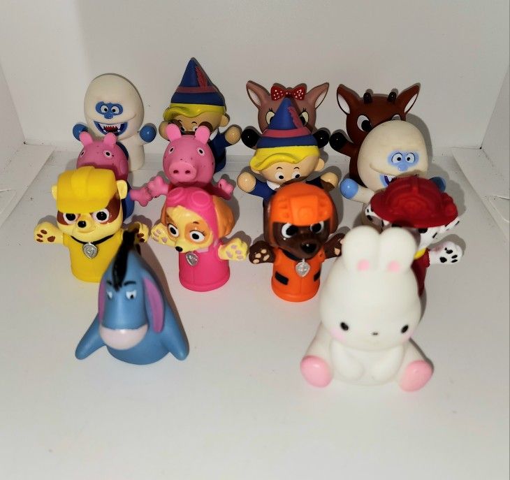 finger puppets from Rudolph the red nose reindeer, Peppa Pig, Paw Patrol, and eeyore
