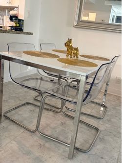 White and Chrome Dining Table with 6 Clear Acrylic Chairs