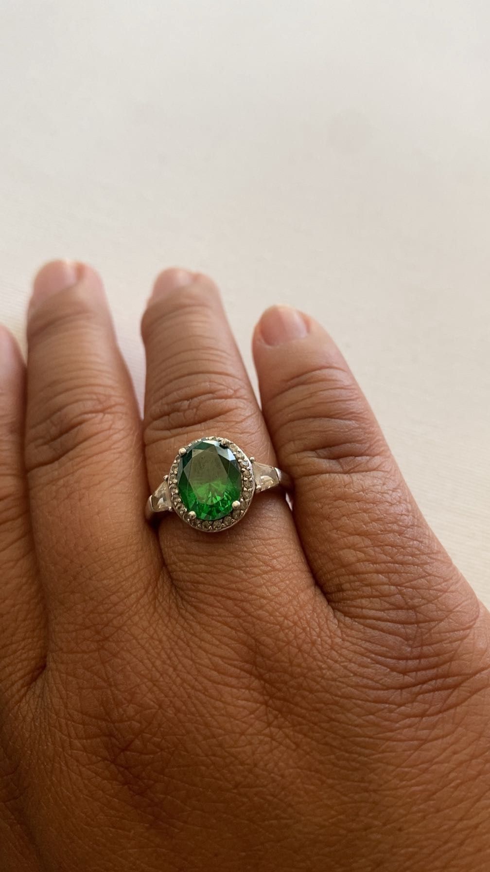 Silver Ring With Emerald Center Piece Surrounded By Sparkling White Gemstones