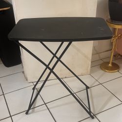 Small black plastic folding table