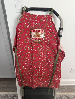 Vintage handmade holiday themed apron featuring a gingerbread “mom’s kitchen”