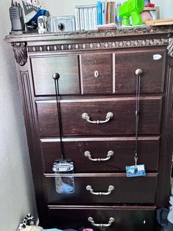 Dark Wood Chest of Drawers with Ornate Details