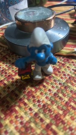 Toy figure Smurf holding a lantern