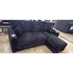 Black corduroy sectional sofa with storage chaise and pull out bed