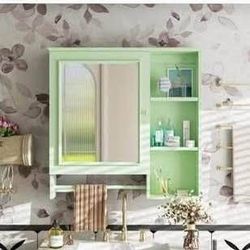 Newly Assembled Green bathroom cabinet with towel hanger and shelf