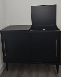 Black record player console with gold accents