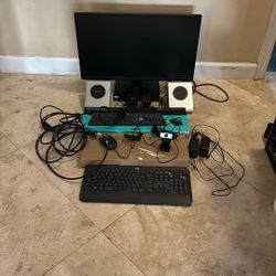 Asus Monitor With 3 Keyboards, A Mouse, Headphones, 2 Launch Ports, A Camera, And A Bunch Of Cables