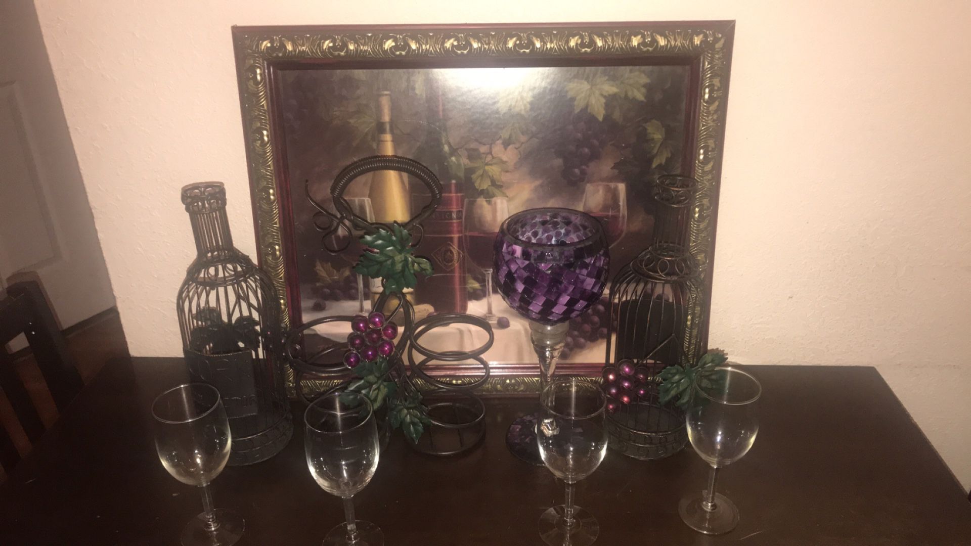 Grapes and wine kitchen decoration. Wall art, corkscrew holders, wine holder, and wine glasses.