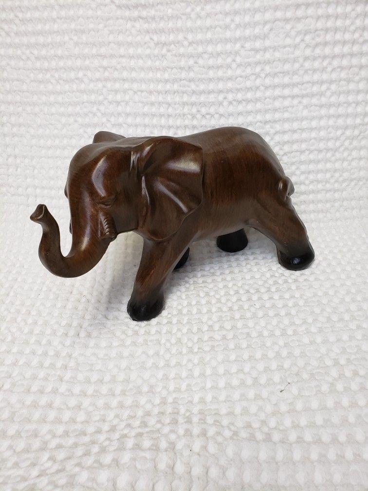 Elephant figurine brown . Not sure if it is ceramic or glass material