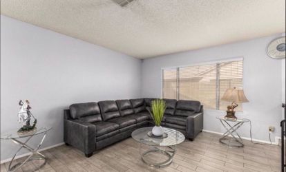 Black leather couch with tables