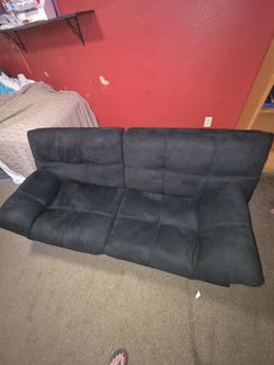 Black futon convertible couch or sofa bed.