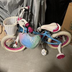 Girls bike with training wheels and helmet
