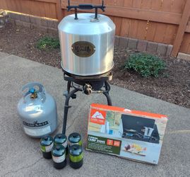 Сamping gas stove, propane cylinders, and chicken grill. $30 for everything.