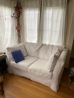 White slipcover loveseat sofa