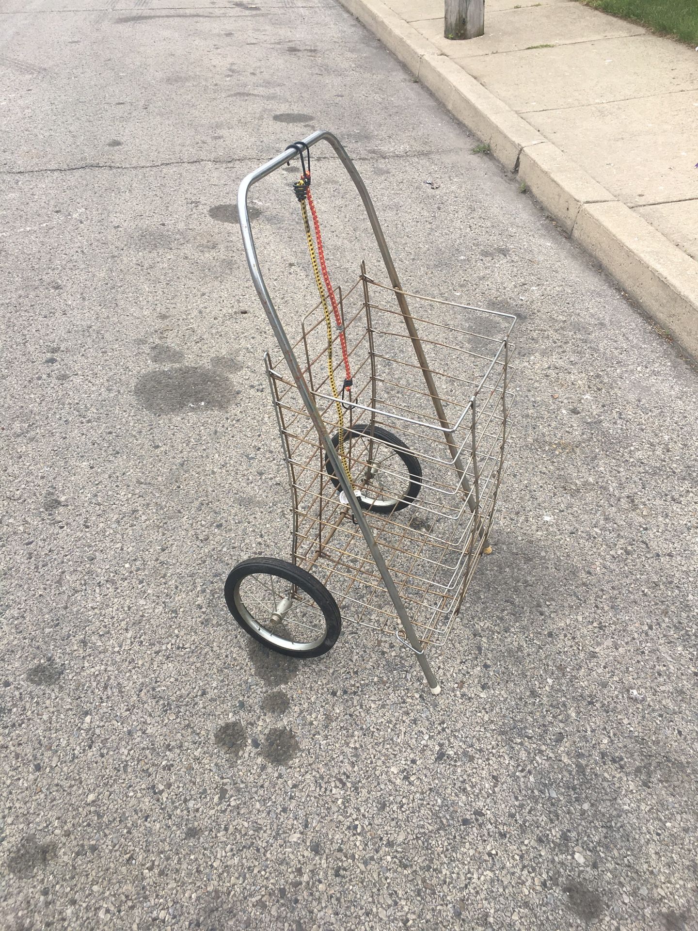 A GROCERY SHOPPING CART /LAUNDRY CART WITH TWO BUNGEE CORDS LITE WEIGHT AND STURDY FOLDS FLAT USED IN GOOD CONDITION $20.00