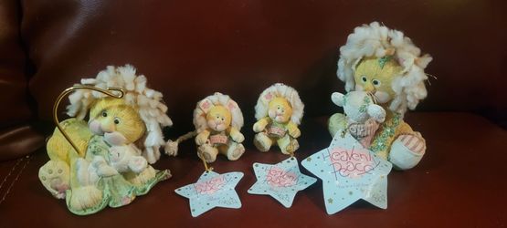 Enesco Heavenly Peace collection, designed by artist Cindy Kiernicki and released in 1995. The collection features whimsical resin lion figurines and 