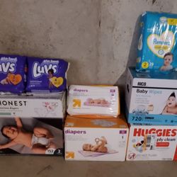 4 Packs Of Diapers, 2 Boxes Of Diapers,& 2 Boxes Of Baby Wipes