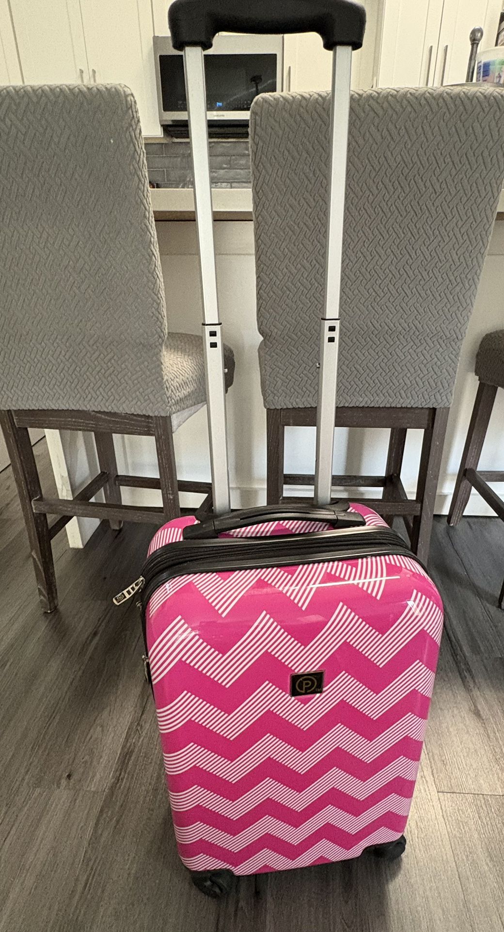 Pink Hardcover Suitcase On Wheels. It measures