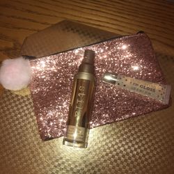 NEW Stilla foundation and shimmering lip gloss cosmetics and a pink sequins glitter makeup bag with a Pom Pom zipper pull
