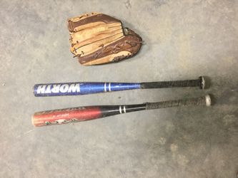 Little league baseball bats and one standard glove