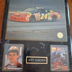 Framed display of Jeff Gordon NASCAR memorabilia, featuring the iconic "Rainbow Warrior" No. 24 car. 