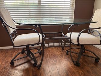 Glass Top Dining Table with 2 Swivel Chairs- wrought iron frame.