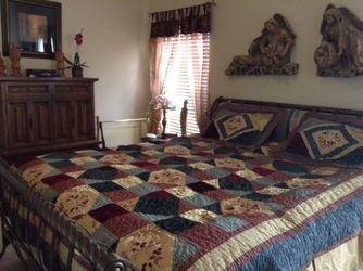 King size coverlet, pillow shams, dust ruffle, 2 sets of matching curtains and tie backs.