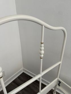IKEA twin bed frame in white with gold accents