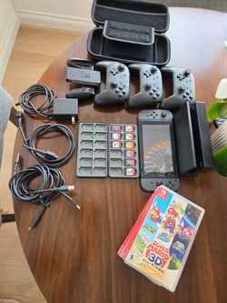 Nintendo Switch with controllers and  9 Mario Bros games