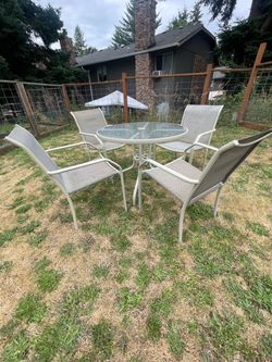Round table and four comfortable chairs, all in good condition.
