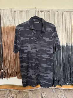 Black camo print Travis Mathew polo with Kings River Golf & Country Club embroidered logo on the left arm; perfect condition
