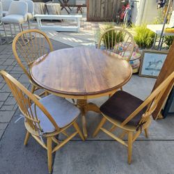 42 inch solid oak dining table and four chairs and multi colored seat cushions.  Comes with qty 1: 10 inch leaf (extender)