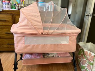Pink baby bassinet