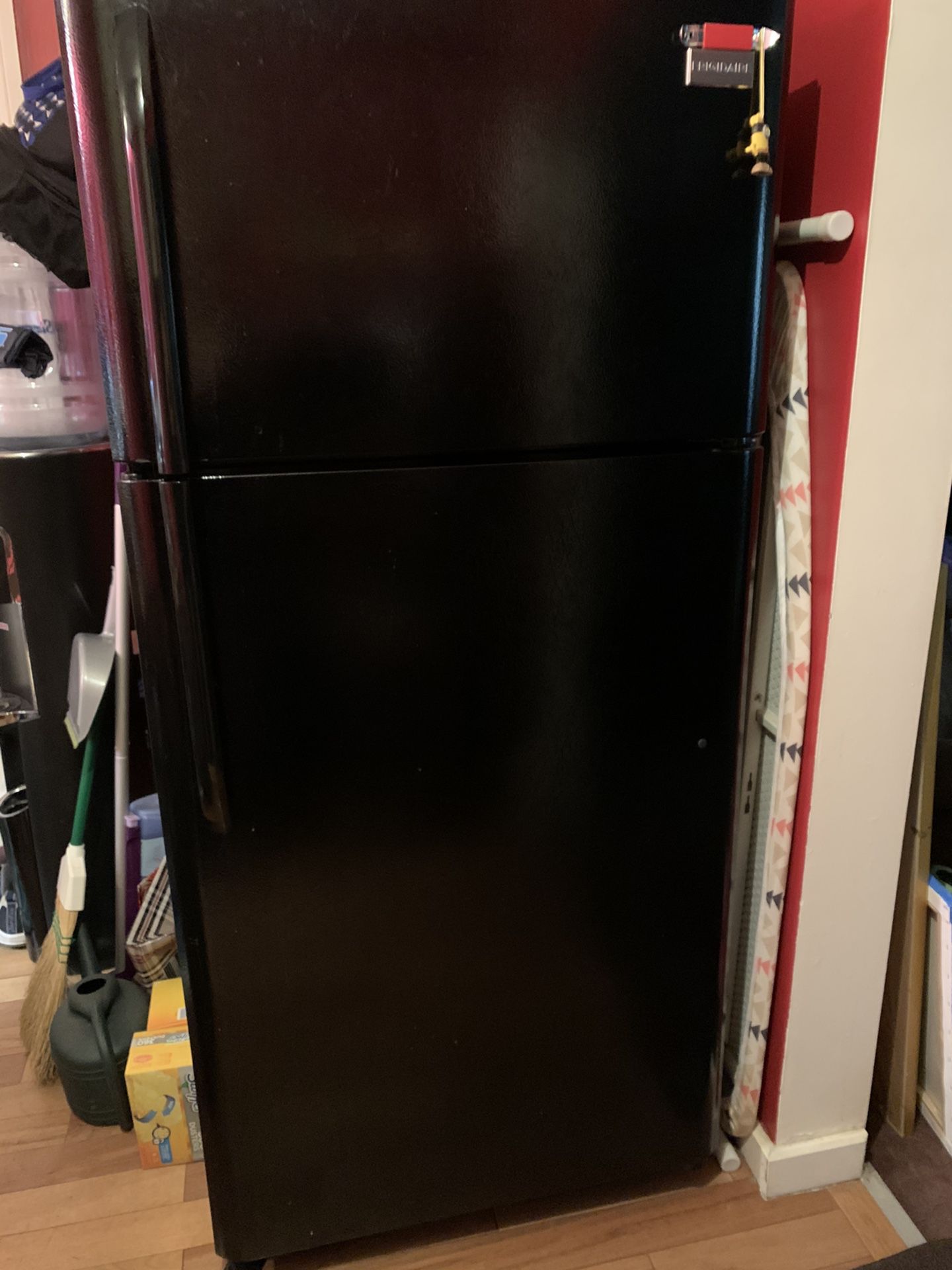 Upright Frigidaire refrigerator in black and a Frigidaire ceramic top stove that is self cleaning and only 4 years old. Minimal wear and tear. They