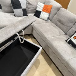 Light gray sectional couch with ottoman
