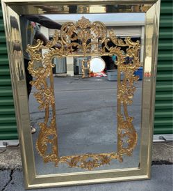 4ft high and 3ft wide  Vintage gold-gilt Rococo-style decorative wall mirror features an elaborate, scrollwork-carved frame with floral and acanthus l