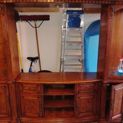 Entertainment center or shelves around Double bed. 