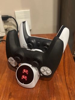 Two Ps5 dual action remotes with charging station