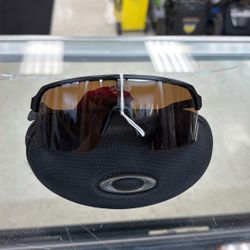 Oakley New Orleans Saints Sutro Lite sunglasses with a matte black frame and brown lenses.        