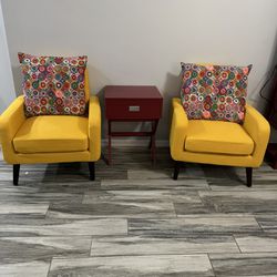 Two armchairs with cushions and red Table