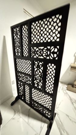 large carved/decorative wooden room divider or privacy screen