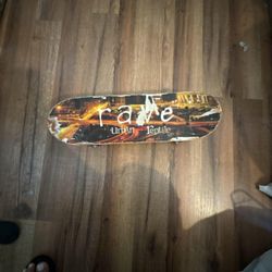 Rave Urban Reptile Skateboard with Cityscape Graphic